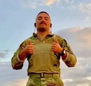 man in military attire giving a thumbs up