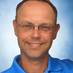 smiling man in blue shirt