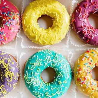 Colorful donuts sitting in a box