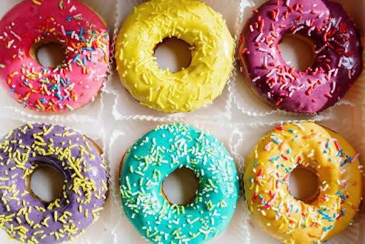 Colorful donuts sitting in a box